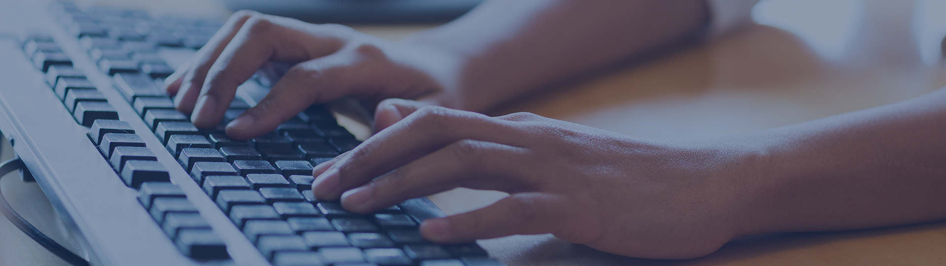 Hands typing on keyboard